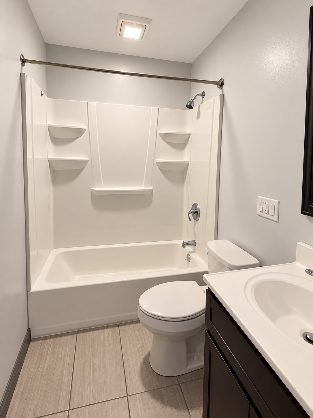 Actual photo of a bathroom with tub and shower, vanity and tile floor
